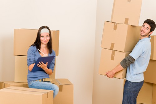 Commercial removals process with labelled boxes and office furniture in Dartford